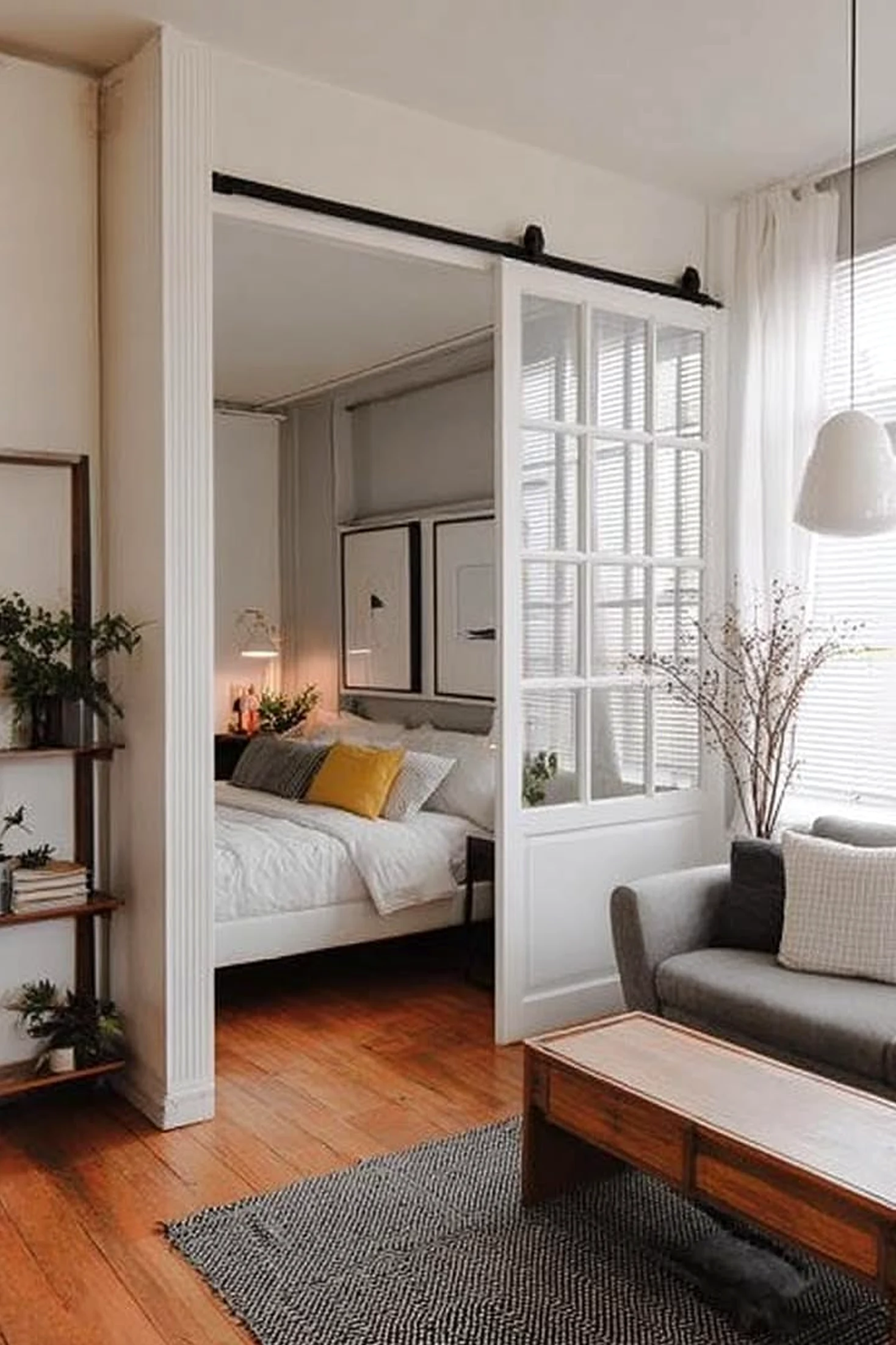 Textured kitchen nook anchors the sitting area with order, giving the view a mood that feels quietly finished.
