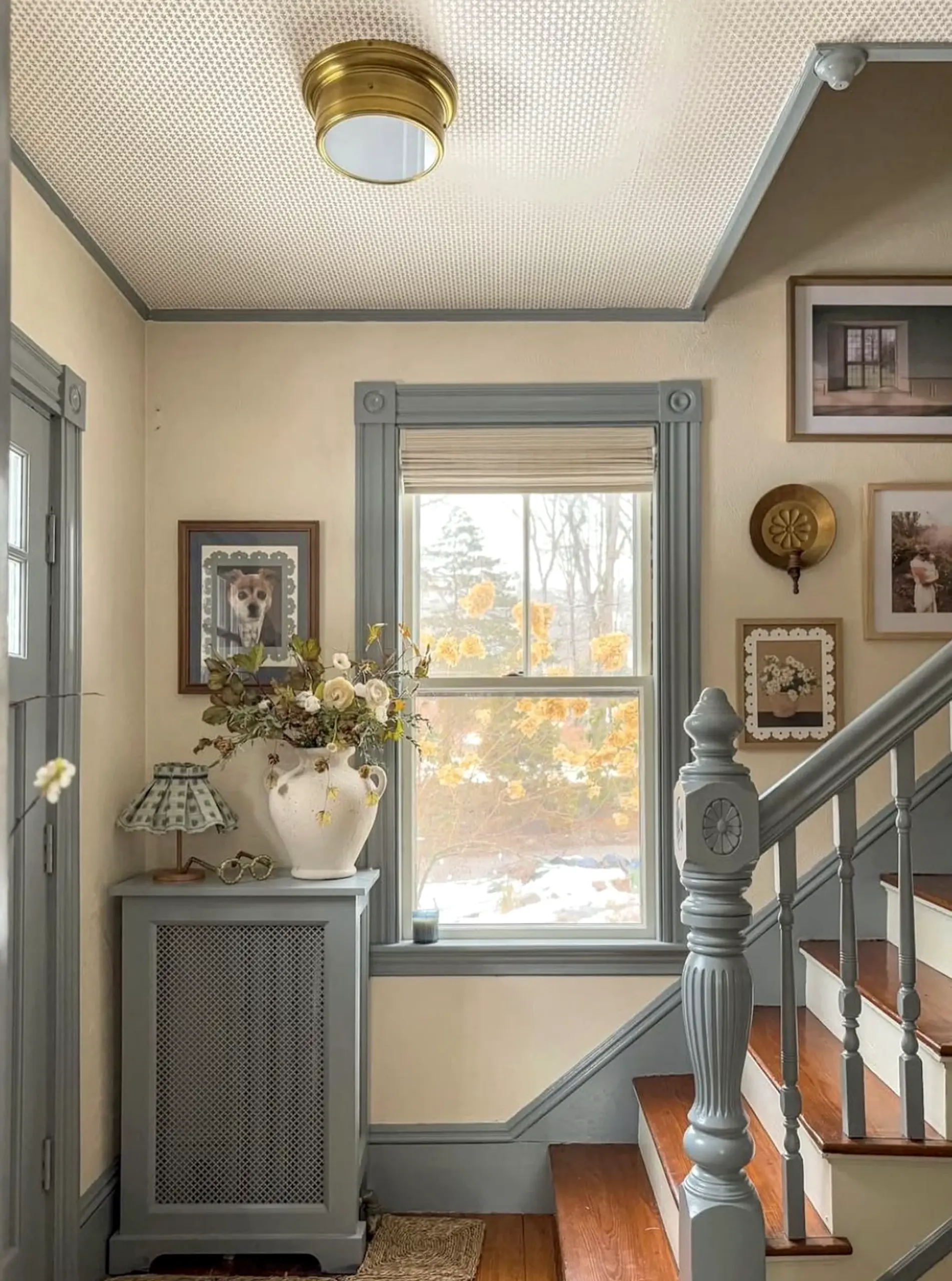 Relaxed green entry supports the corner through character, leaving the space feeling quietly finished.